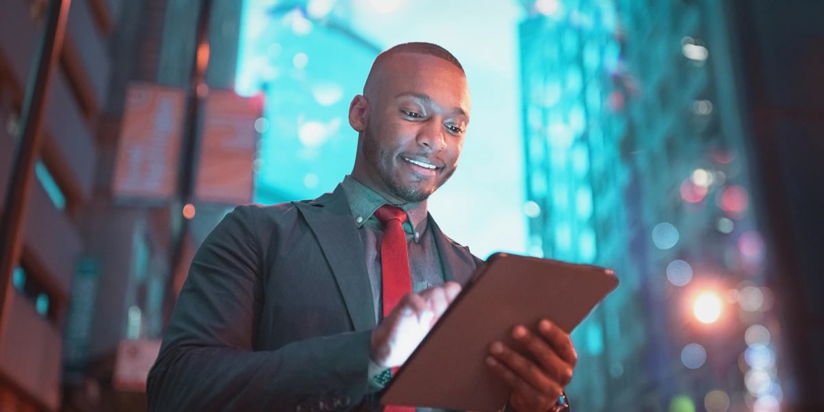 Man looking at tablet in cityscape