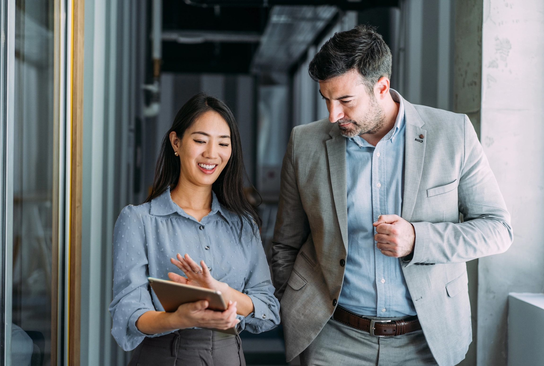 Man and woman walking in office