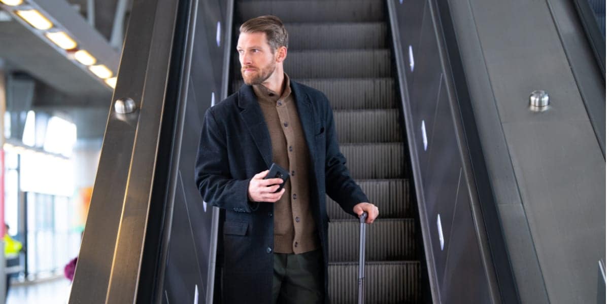 business man travelling on escalator