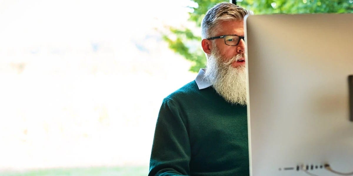 Man with beard on lapptop