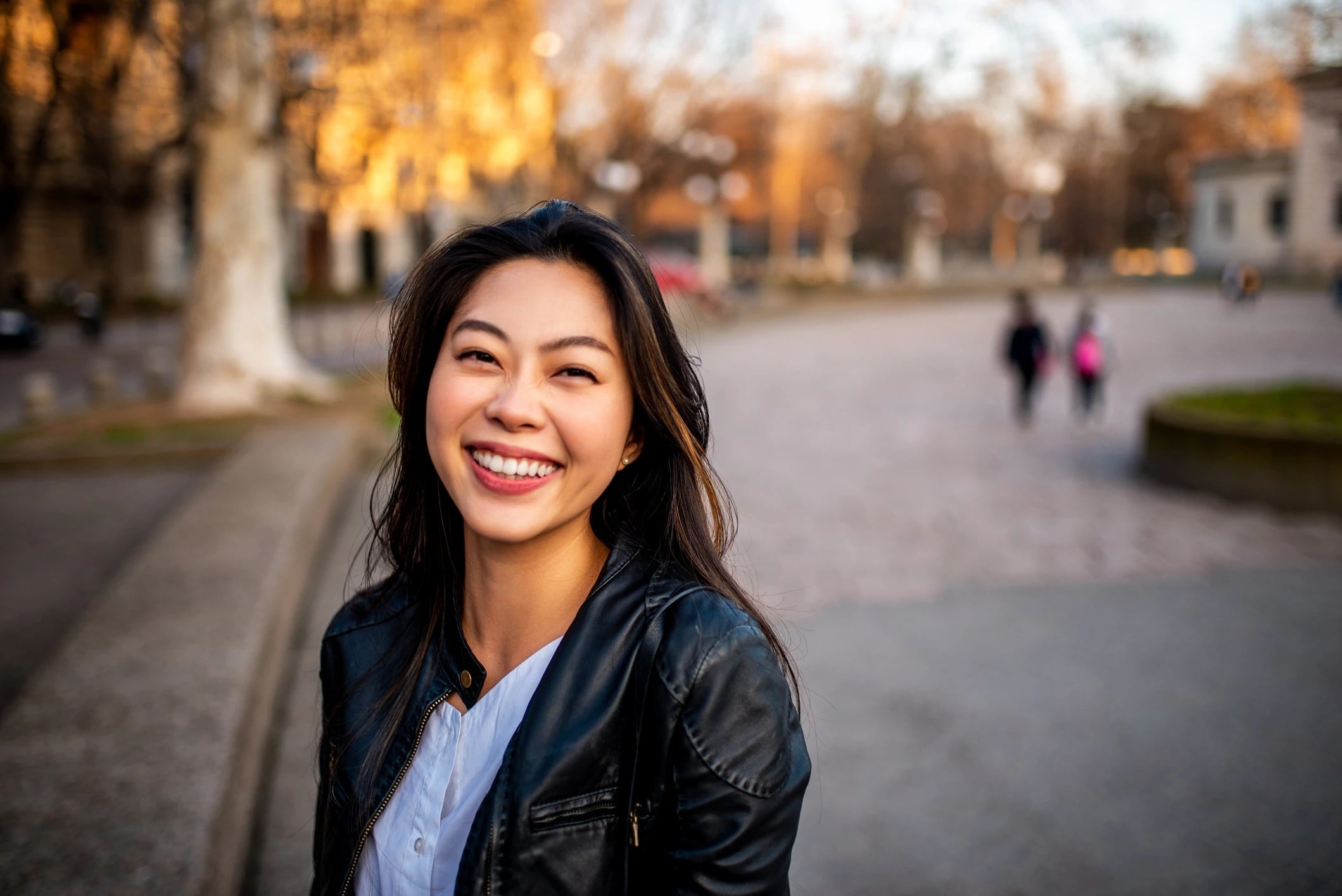 Woman smiles at camera in suburban outdoors
