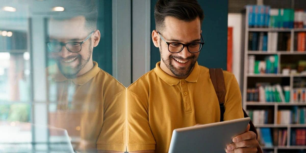 Man smiling at tablet