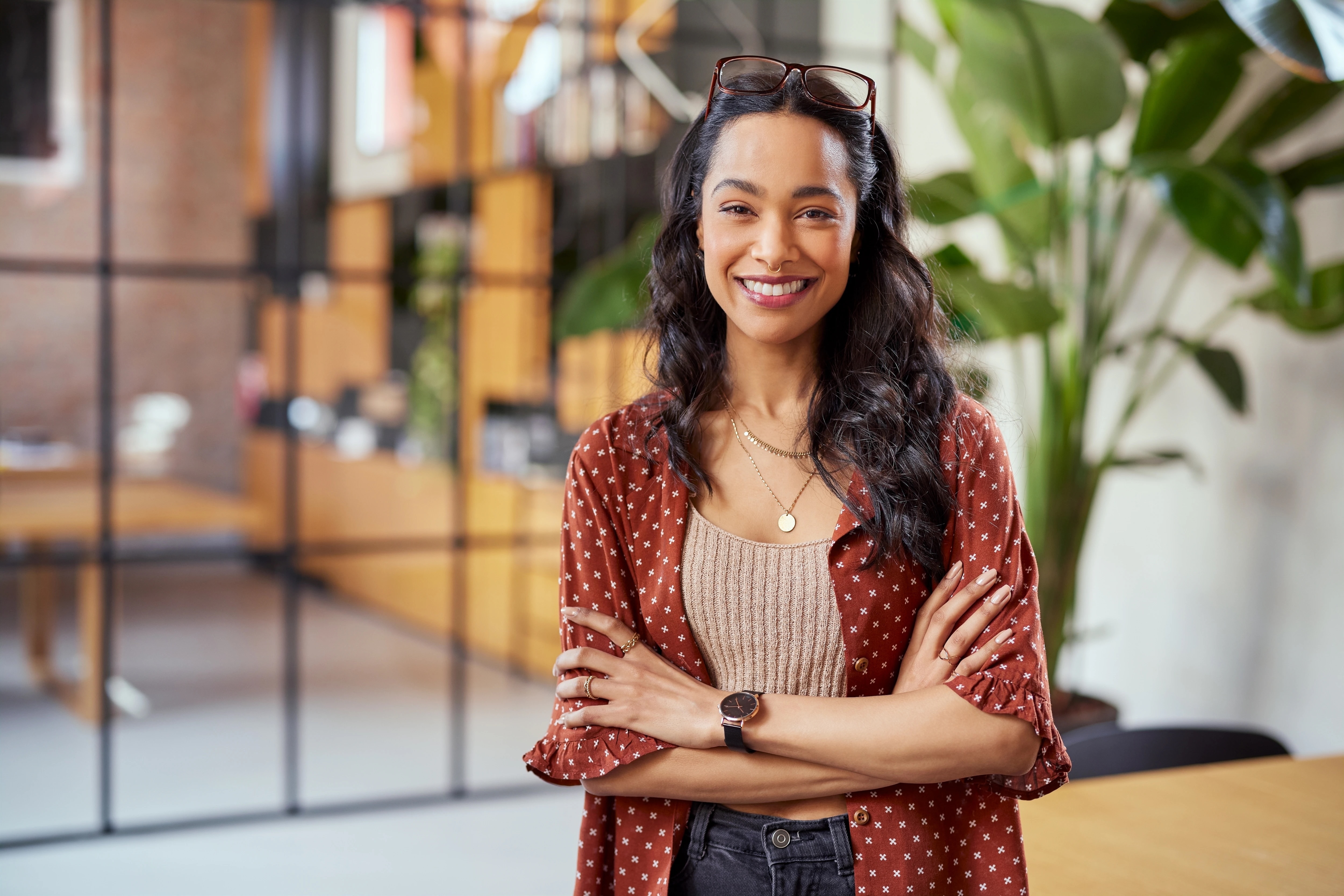 Woman smiles at camera, arms crossed