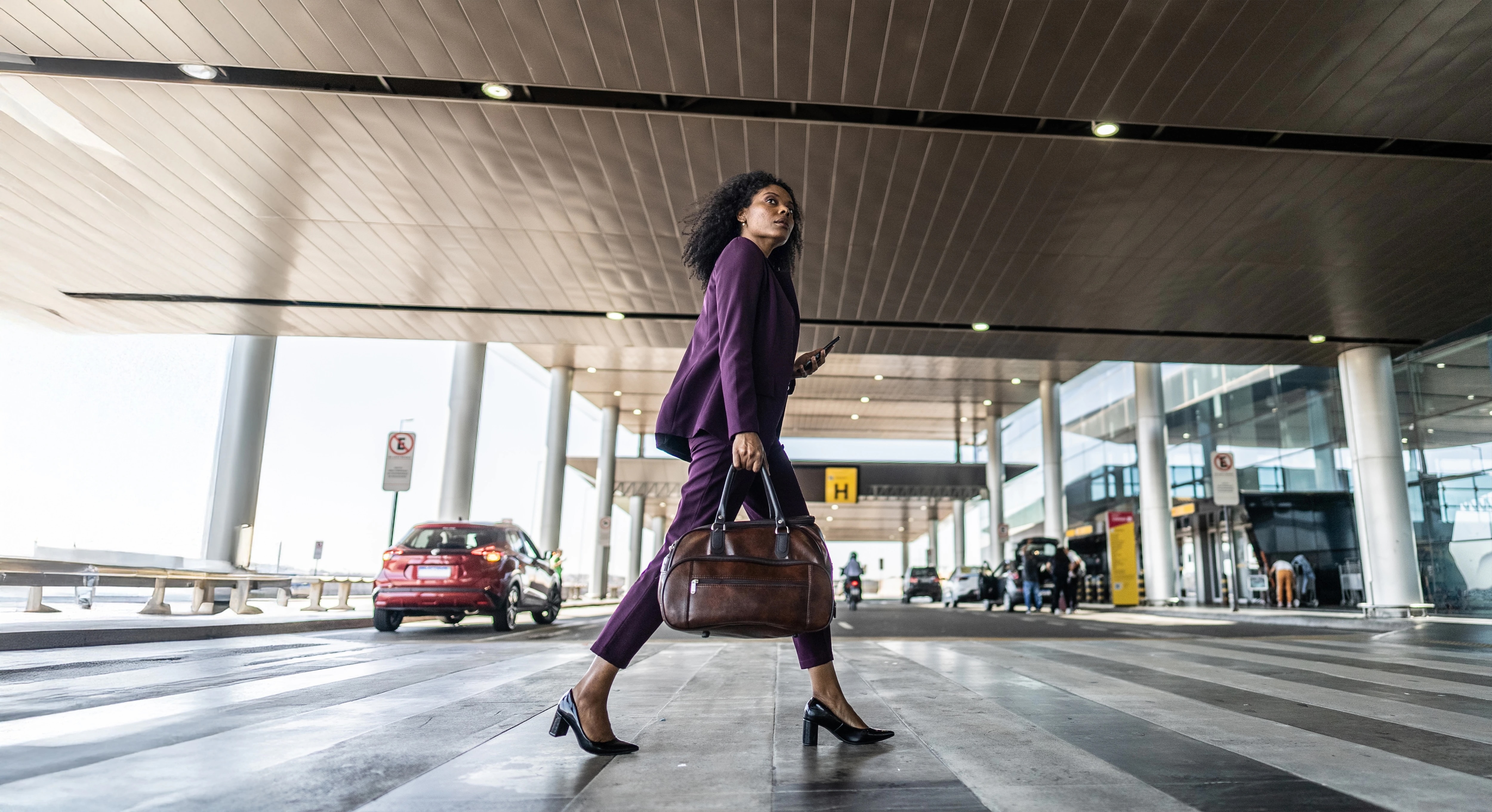Woman walking across road near airport