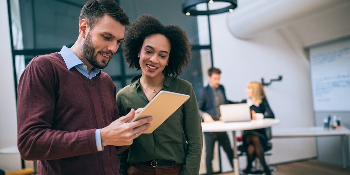 two people having a discussion while analyzing a document