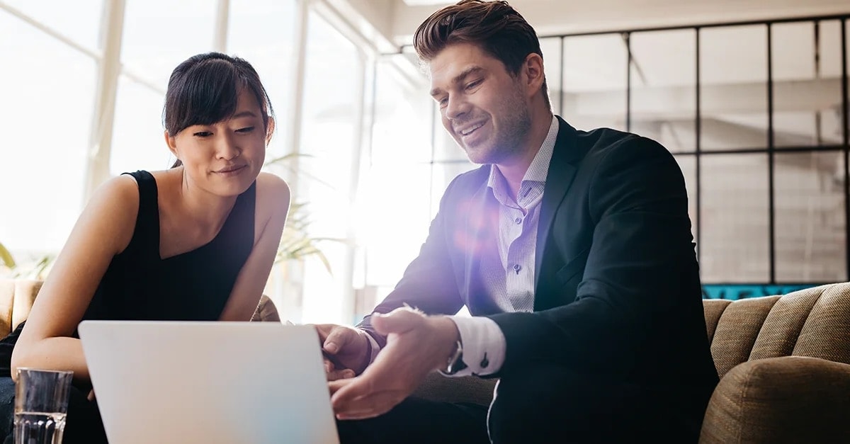 Man and woman looking at laptop