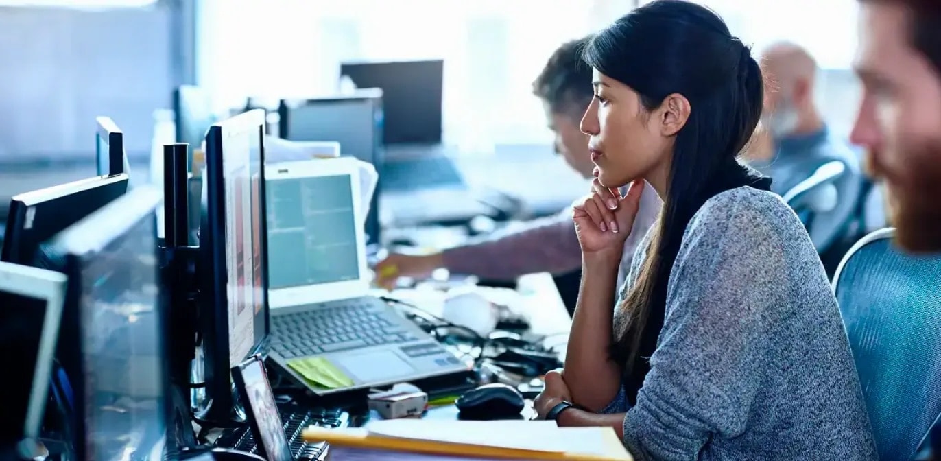 Woman looking at computer in an office