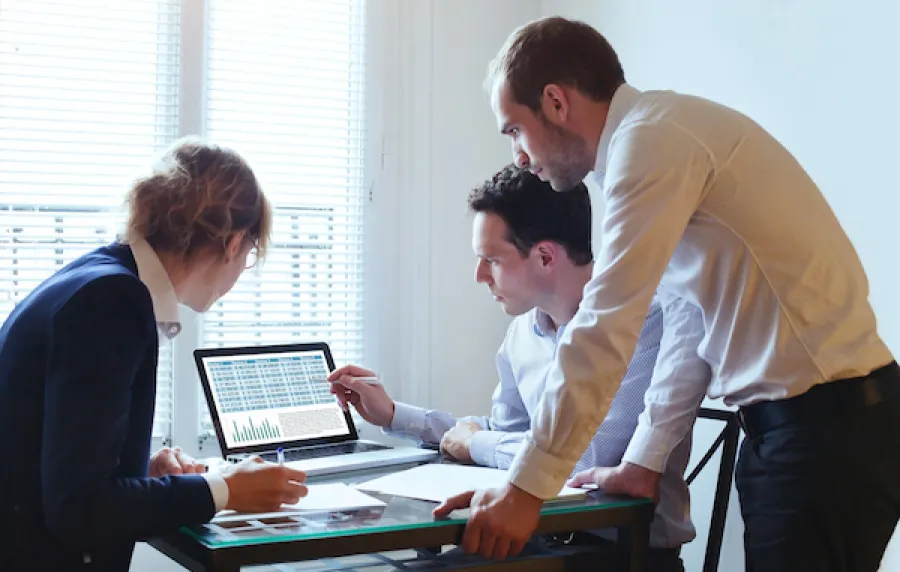 A team looking at data on a computer