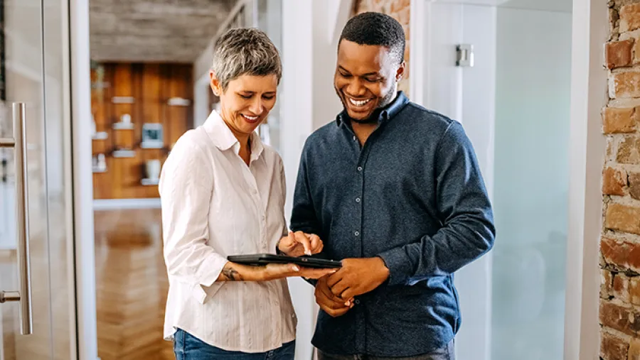 business collaborators working on tablet device