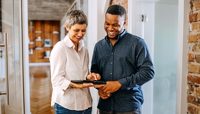 business collaborators working on tablet device