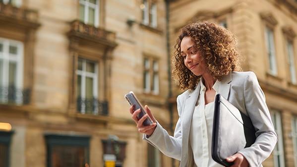 Woman walking while using her phone