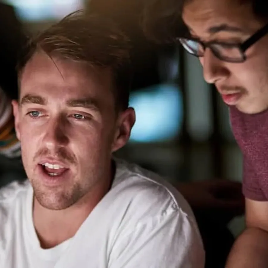 three people collaborating looking at a screen
