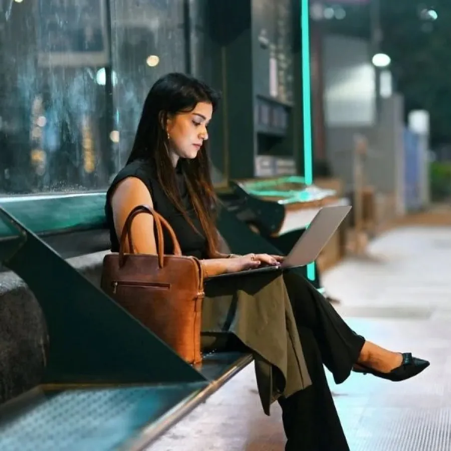 woman working on laptop on bench
