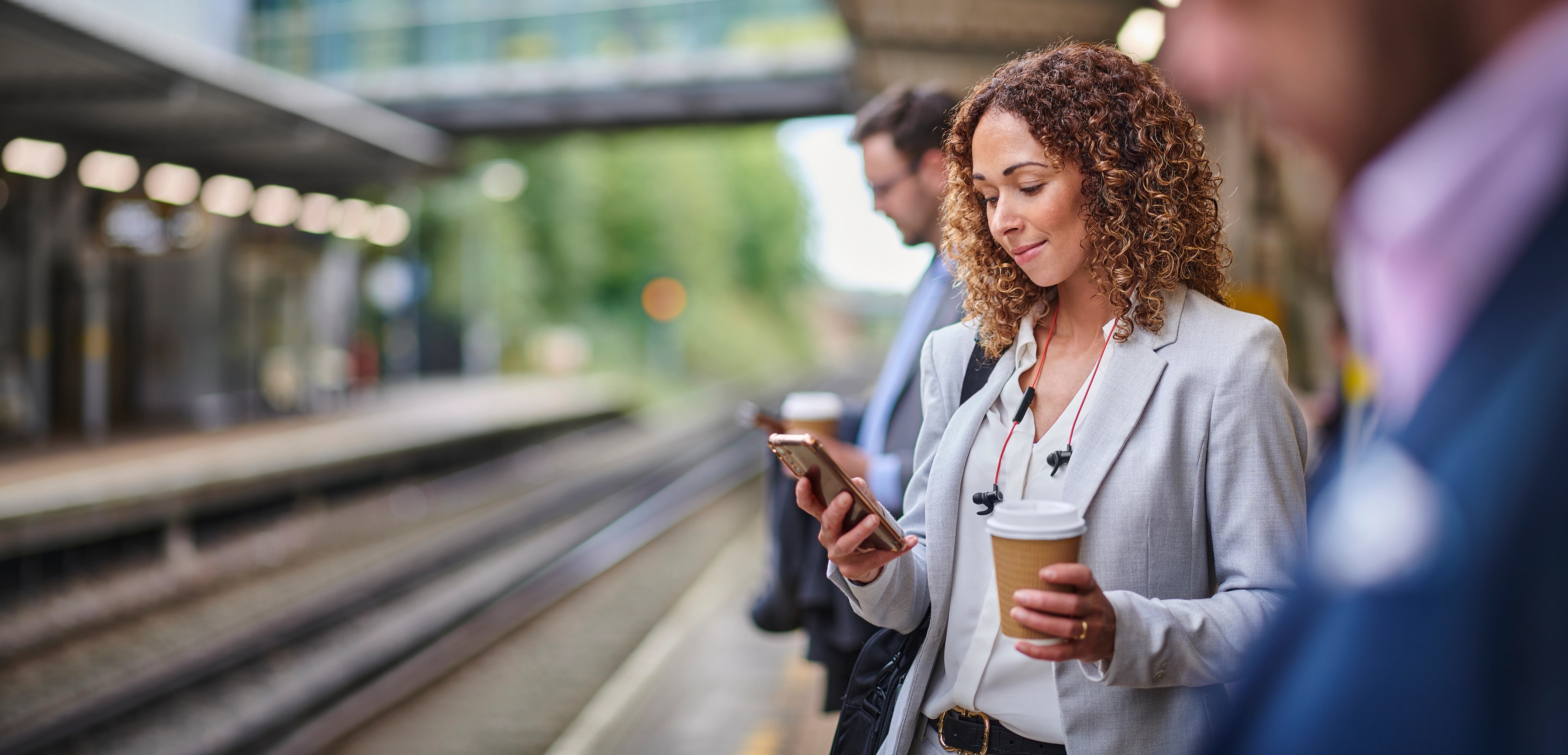 Woman on phone at train platform