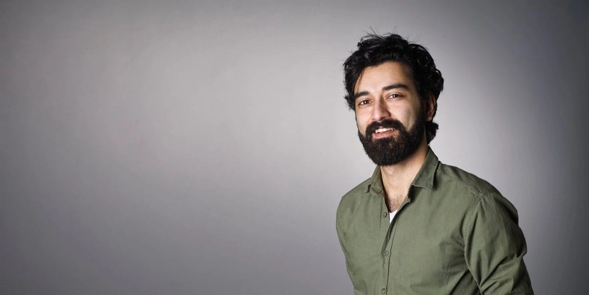 Man in green shirt, grey background