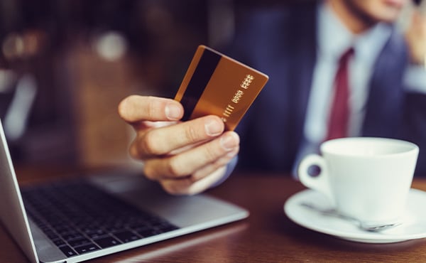 man at cafe paying with card