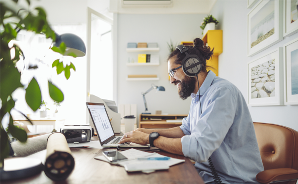 Man wearing headphones working at a computer