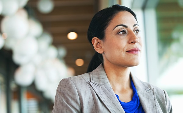 woman in suit looking outside