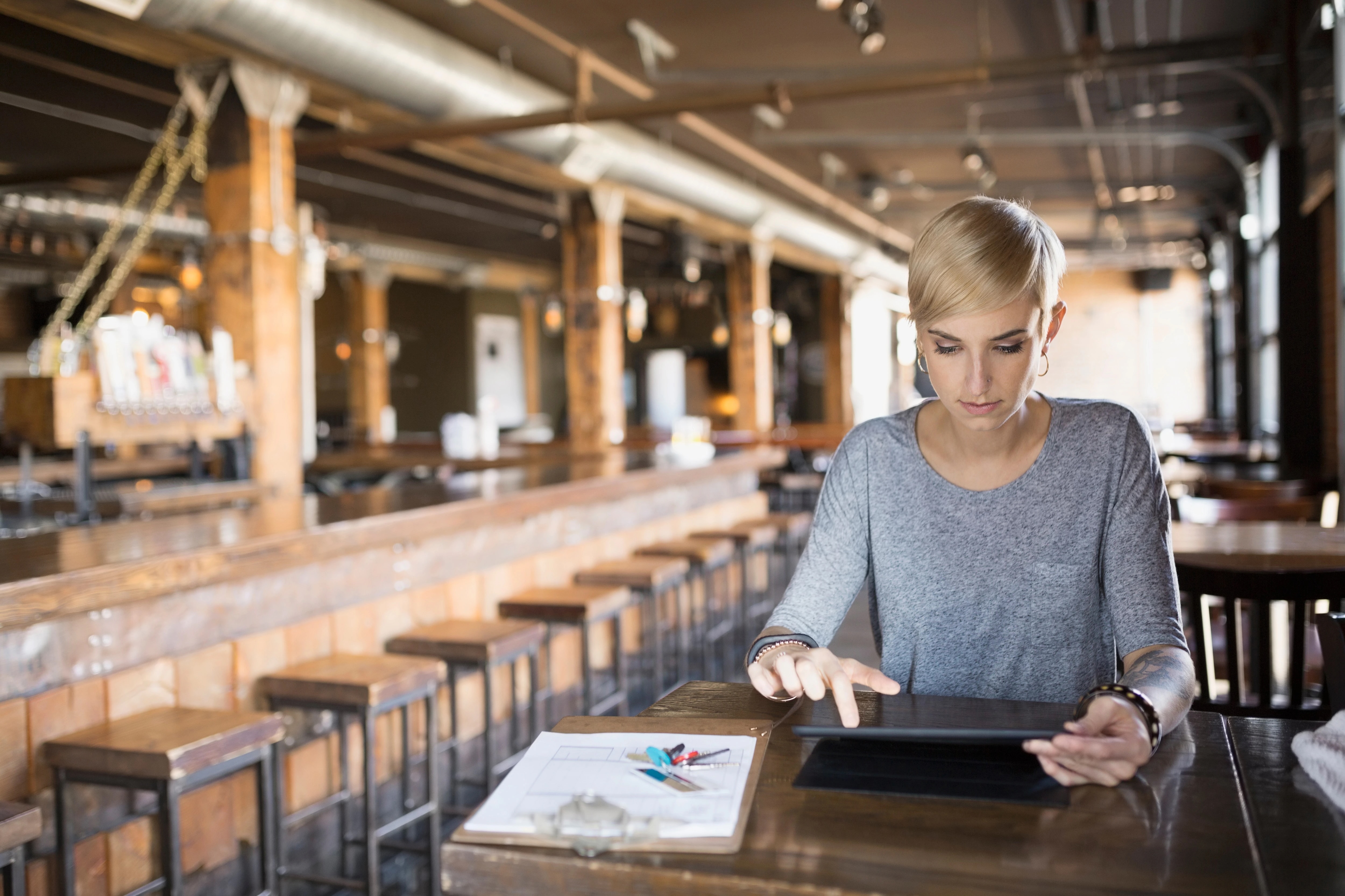 Woman at table working on tablet