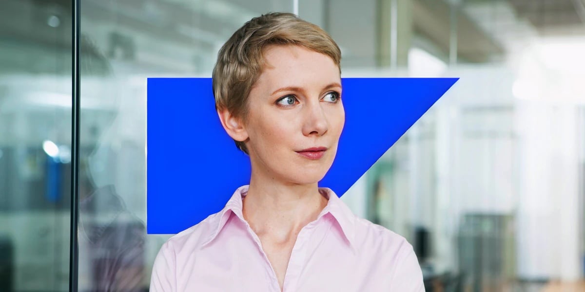 Short-haired woman in front of blue SAP anvil logo