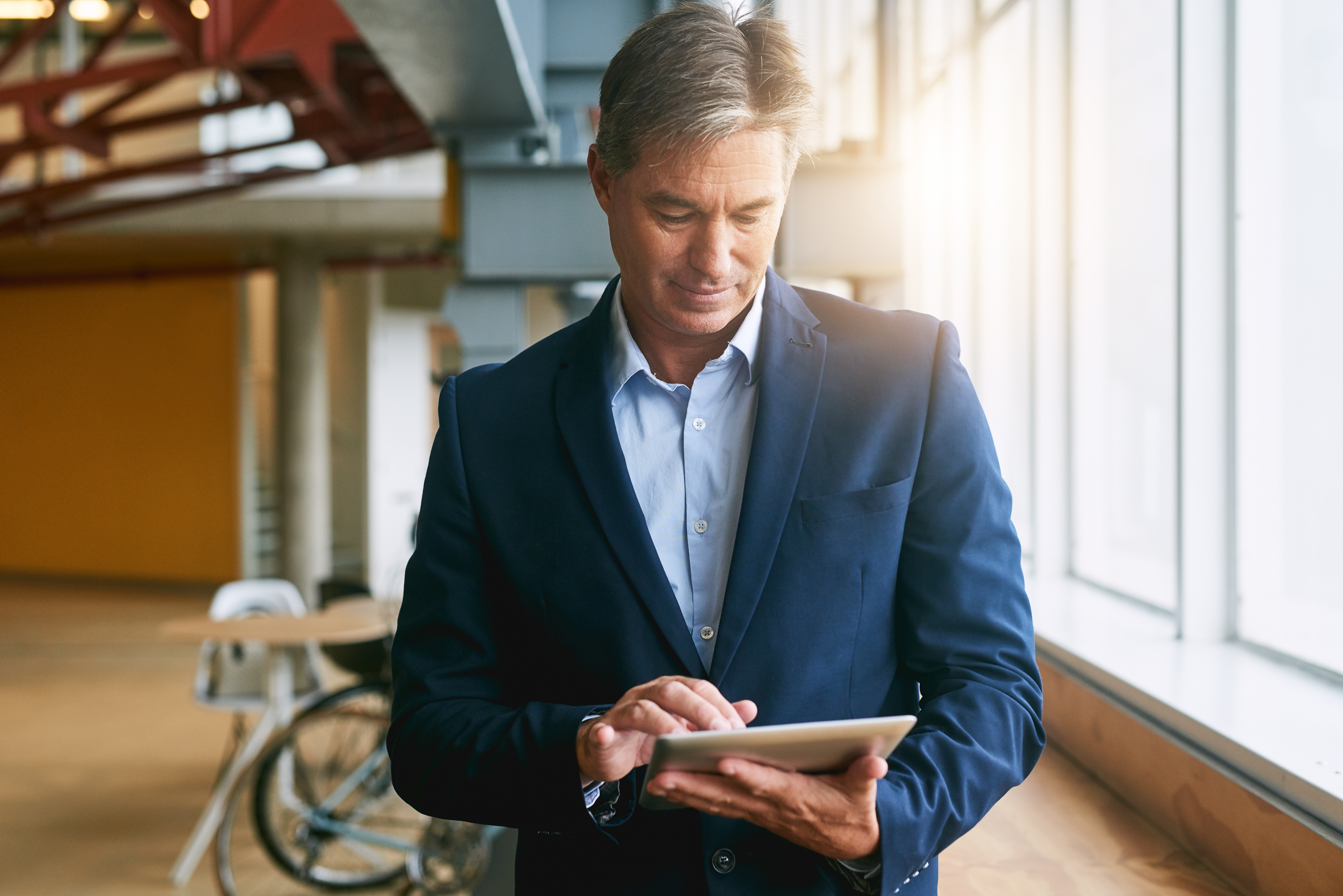 man looking at a tablet