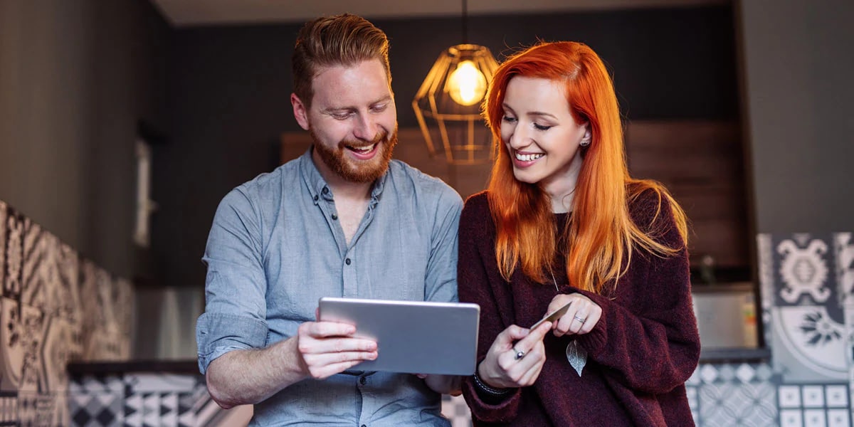 Man and woman looking attablet