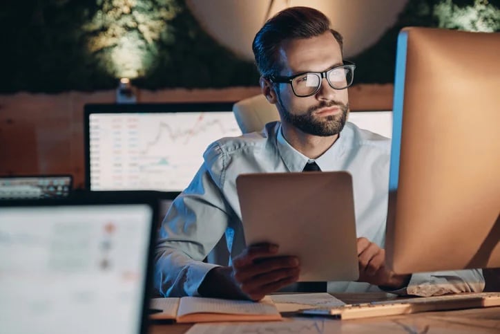 Man in glasses holding tablet