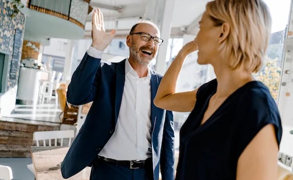 Two colleagues high-fiving