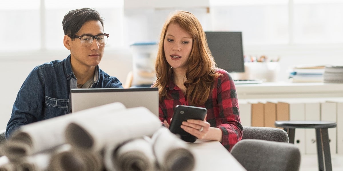 two people working together over a laptop