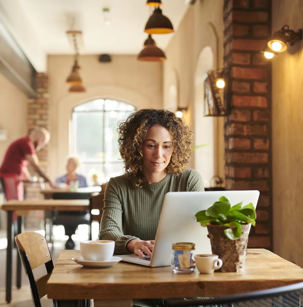 Curly haired woman at computer