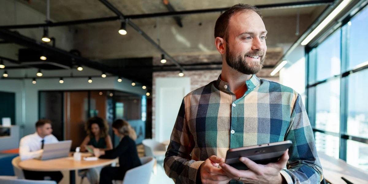 Man in plaid holding tablet