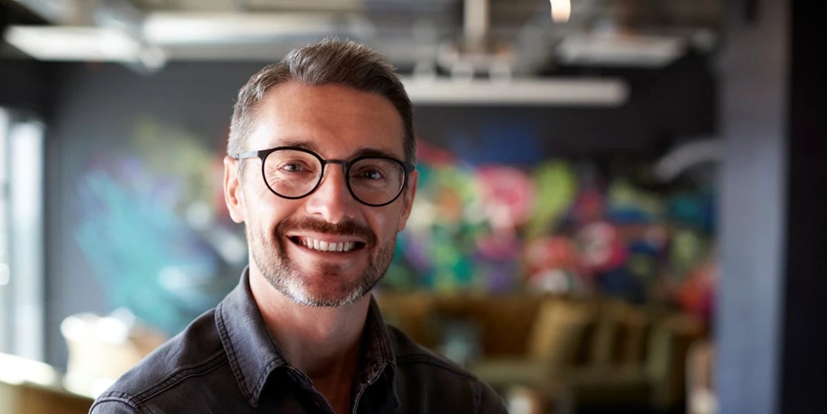 Man with glasses smiling