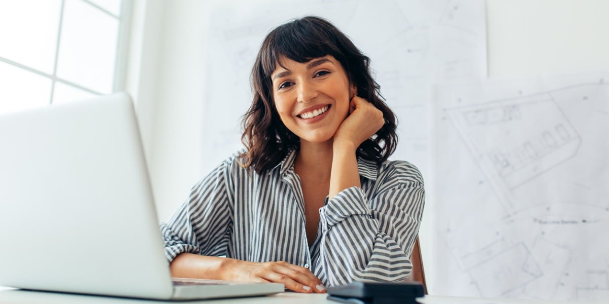 woman with a laptop smiling