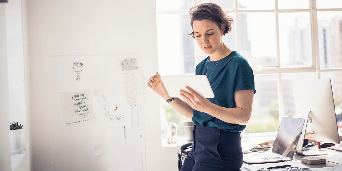 woman indoors looking at tablet